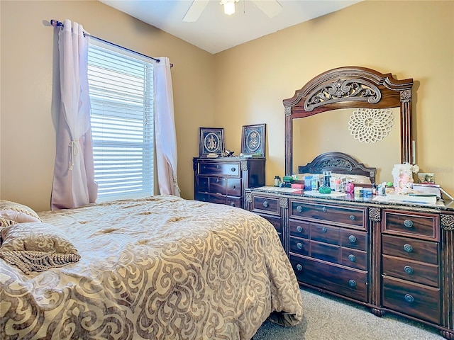 bedroom with ceiling fan and light carpet