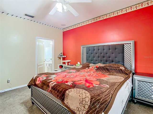 carpeted bedroom featuring ensuite bath and ceiling fan