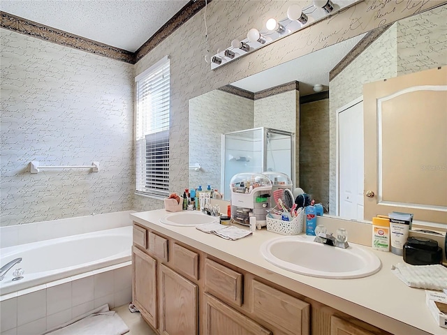 bathroom with vanity, plus walk in shower, and a textured ceiling