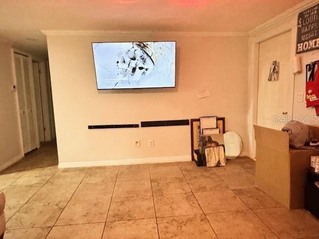 tiled empty room featuring ornamental molding