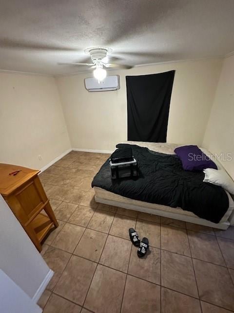 bedroom with a textured ceiling, a wall unit AC, and ceiling fan