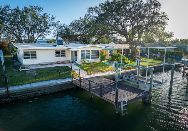 dock area featuring a yard and a water view