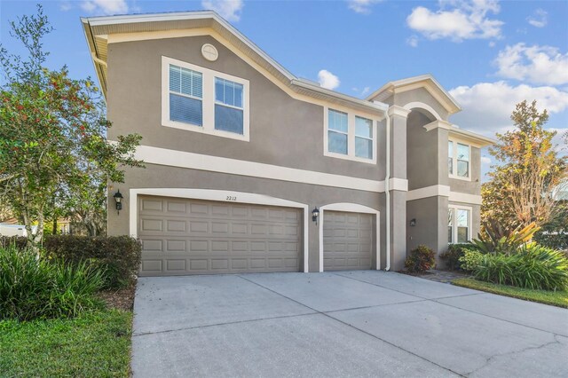 2212 Valterra Vista Way, Valrico, FL 33594 - view of front of property with stucco siding, a garage, and driveway