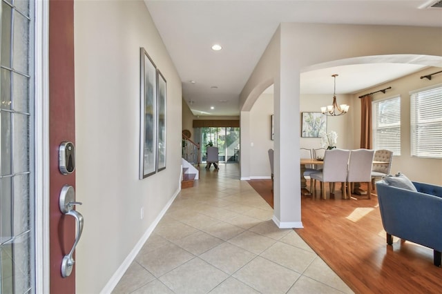 2212 Valterra Vista Way, Valrico, FL 33594 - entryway featuring arched walkways, light tile patterned floors, a chandelier, recessed lighting, and stairs