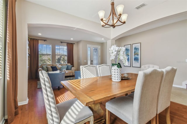 2212 Valterra Vista Way, Valrico, FL 33594 - dining room with arched walkways, a chandelier, recessed lighting, and wood finished floors
