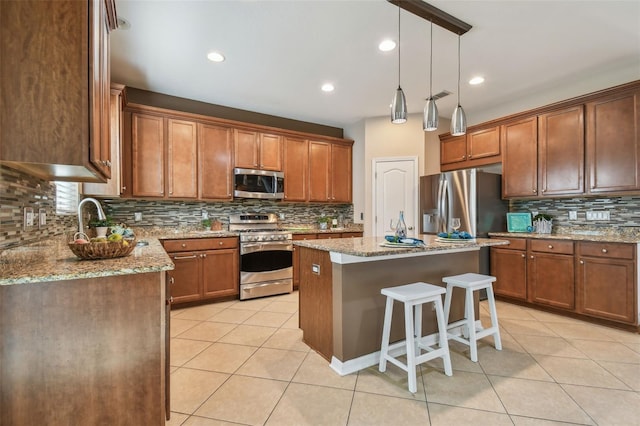 2212 Valterra Vista Way, Valrico, FL 33594 - kitchen with appliances with stainless steel finishes, decorative backsplash, light tile patterned flooring, a kitchen island, and light stone countertops