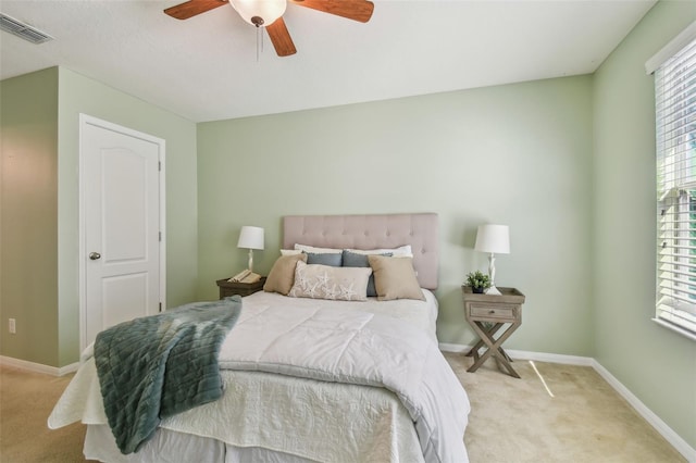 bedroom with ceiling fan and light carpet