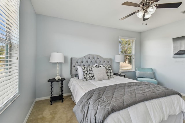 bedroom featuring light carpet and ceiling fan