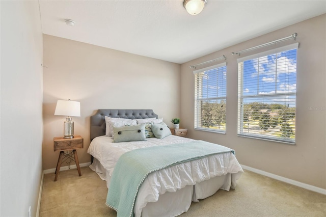 bedroom featuring light carpet