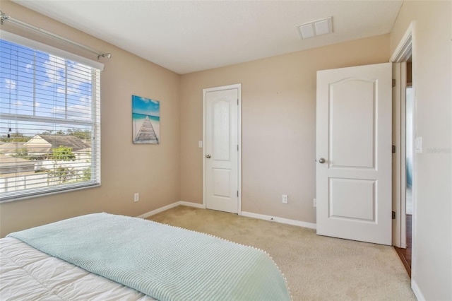 carpeted bedroom featuring multiple windows