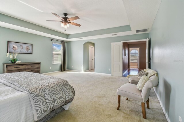 2212 Valterra Vista Way, Valrico, FL 33594 - carpeted bedroom with a raised ceiling, arched walkways, and ceiling fan