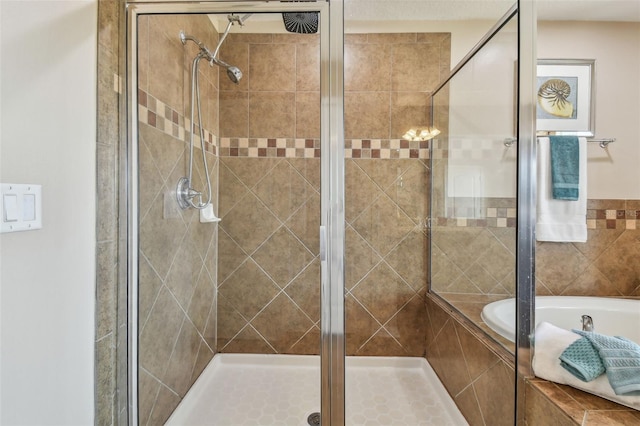 bathroom with separate shower and tub