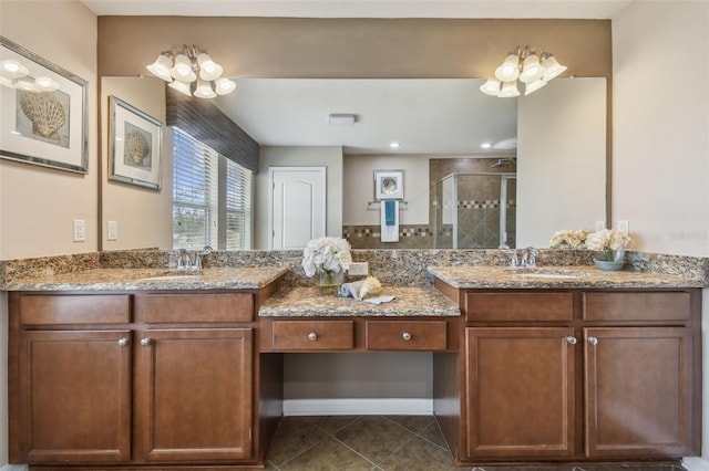 bathroom with tile patterned floors, vanity, and a shower with door