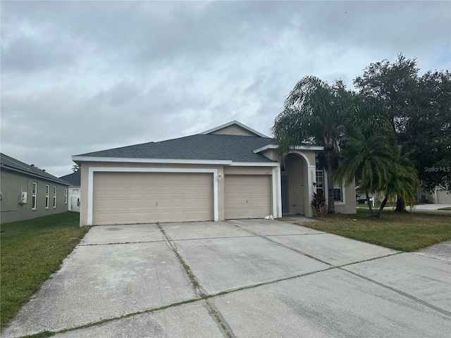 single story home with a garage and a front yard