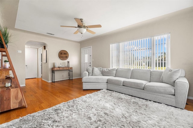 living room featuring ceiling fan and light hardwood / wood-style flooring