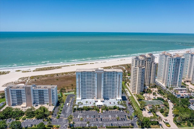 drone / aerial view featuring a water view and a beach view