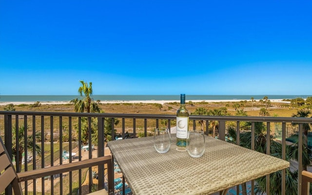 balcony with a view of the beach and a water view