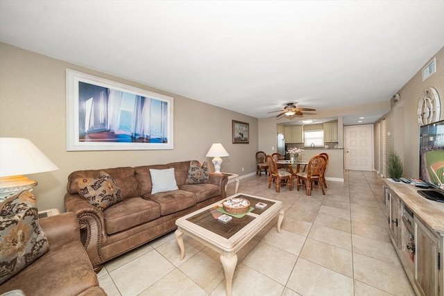 tiled living room with ceiling fan