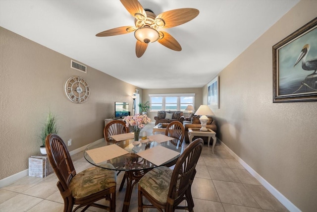 dining room with ceiling fan and light tile patterned floors