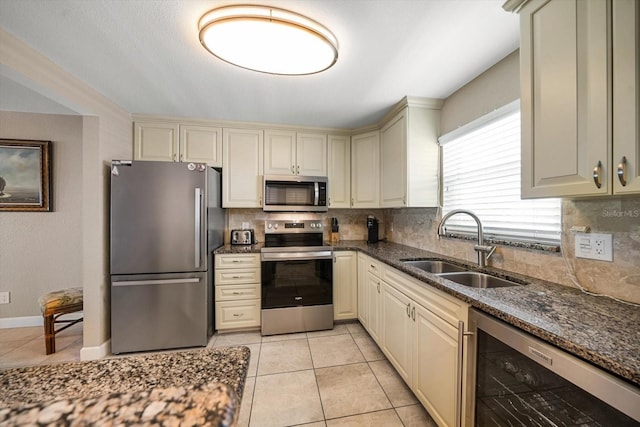 kitchen with backsplash, beverage cooler, sink, and appliances with stainless steel finishes