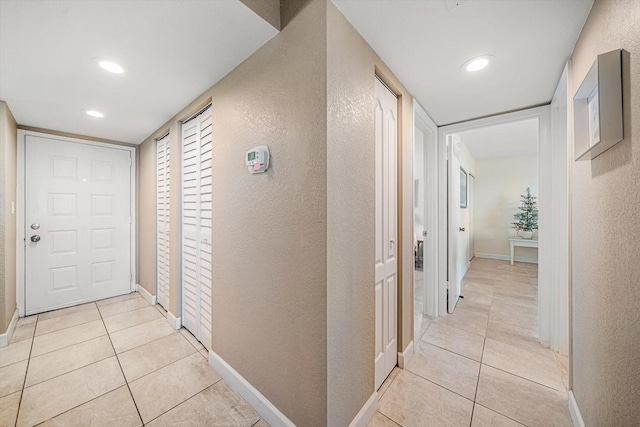 corridor featuring light tile patterned floors