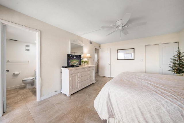 tiled bedroom with ensuite bath, ceiling fan, and a closet