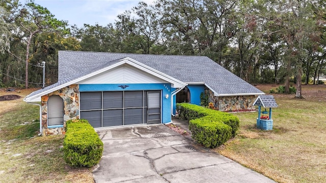 single story home featuring a front yard and a garage