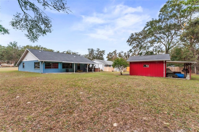 view of yard featuring a carport and a shed