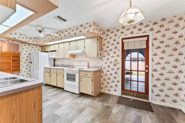 kitchen featuring pendant lighting, white appliances, ceiling fan, light wood-type flooring, and a textured ceiling