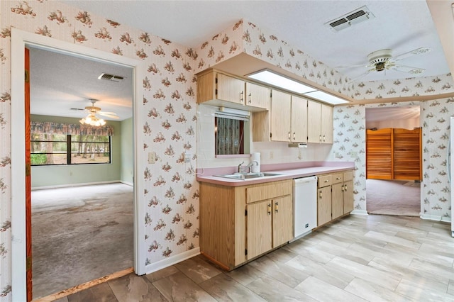 kitchen with light carpet, a textured ceiling, white dishwasher, ceiling fan, and sink