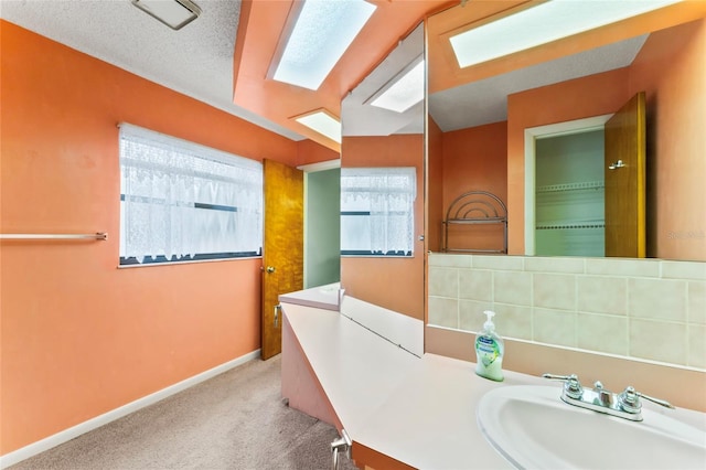 bathroom featuring sink and a textured ceiling