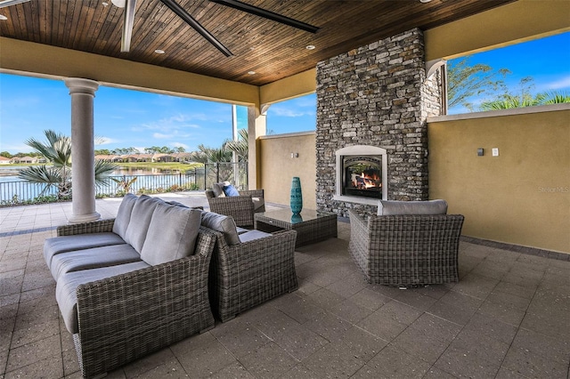 11726 Renaissance Blvd, Venice, FL 34293 - view of patio / terrace featuring an outdoor living space with a fireplace and a water view
