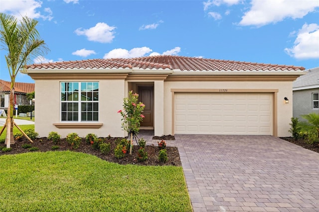 view of front facade featuring stucco siding, decorative driveway, and a garage