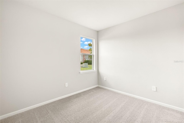 unfurnished room with baseboards and carpet floors