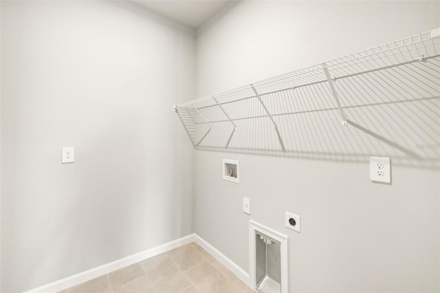 clothes washing area featuring washer hookup, electric dryer hookup, baseboards, and light tile patterned floors