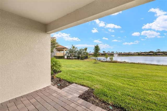 view of grassy yard with a water view