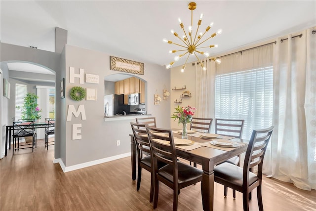 dining space with a chandelier and hardwood / wood-style floors