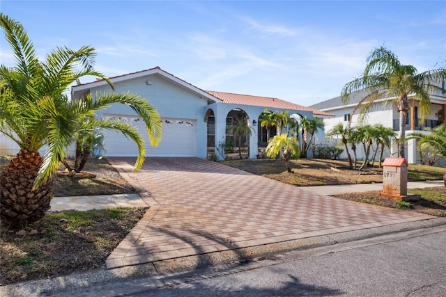 mediterranean / spanish house featuring a garage