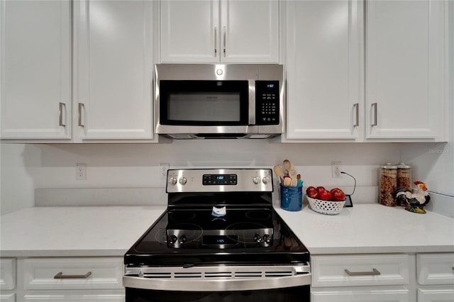 kitchen featuring white cabinets and appliances with stainless steel finishes