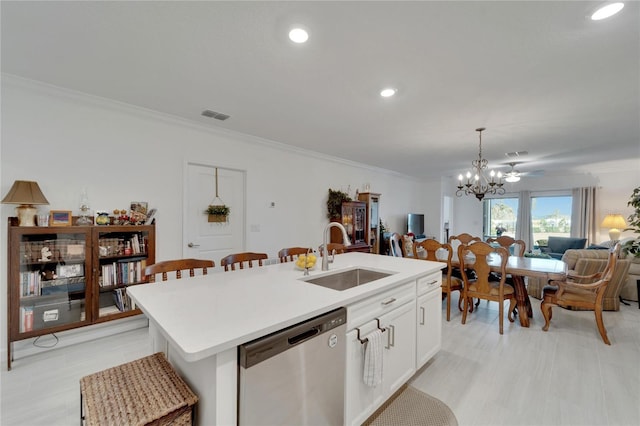 kitchen with stainless steel dishwasher, pendant lighting, a center island with sink, white cabinets, and sink