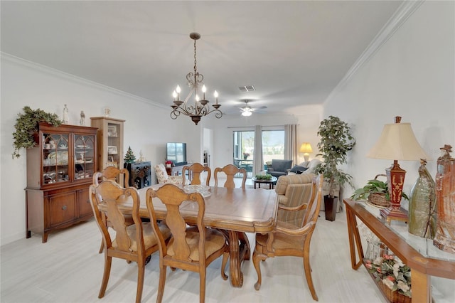 dining space featuring ceiling fan with notable chandelier and crown molding