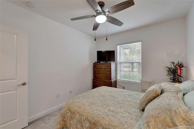 bedroom featuring ceiling fan and light carpet