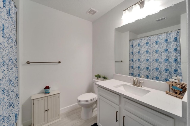 bathroom featuring toilet and vanity