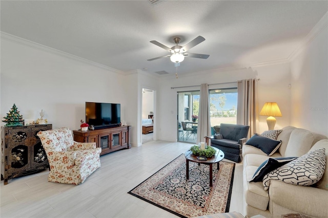 living room featuring ornamental molding and ceiling fan