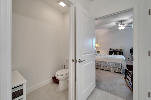 bathroom with toilet and ceiling fan