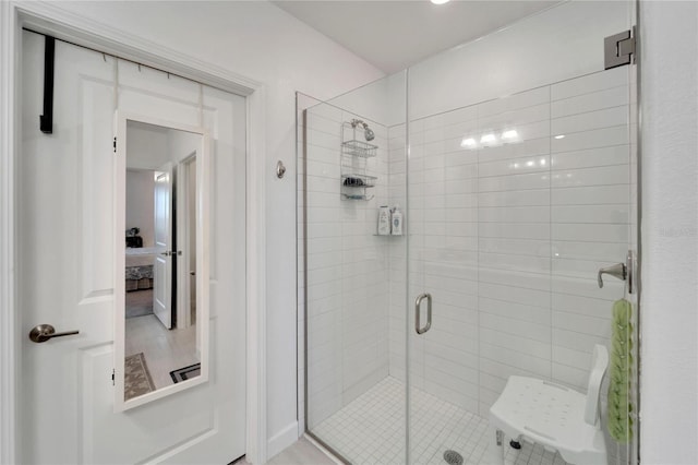 bathroom with a shower with door