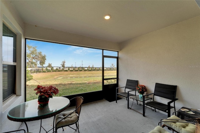 sunroom / solarium with a rural view