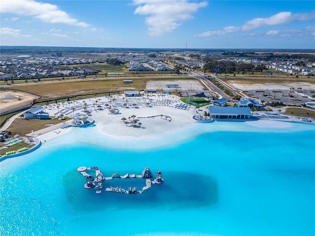 birds eye view of property featuring a beach view and a water view