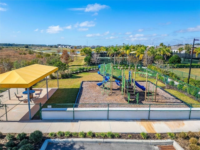 view of jungle gym featuring a lawn