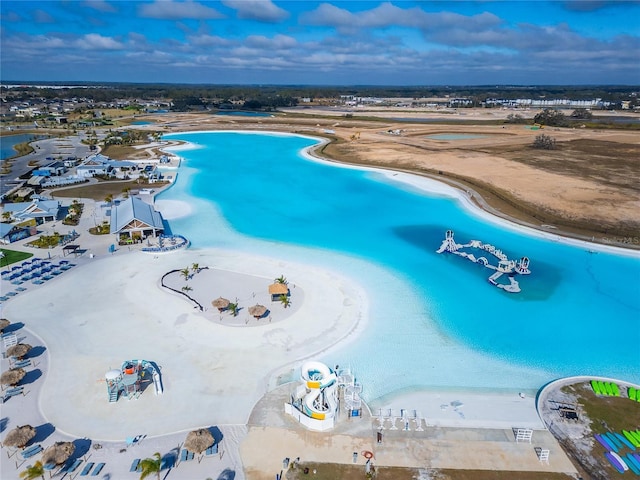 aerial view featuring a view of the beach and a water view